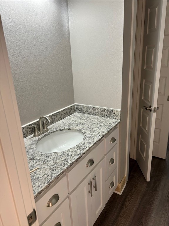 bathroom with hardwood / wood-style floors and vanity