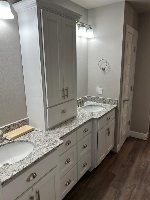 4833 W Planetree St, Fayetteville, AR 72704 - full bathroom featuring double vanity, wood finished floors, and a closet
