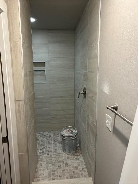 4833 W Planetree St, Fayetteville, AR 72704 - bathroom with a tile shower and recessed lighting