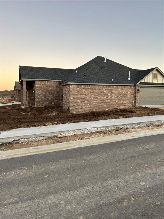 4833 W Planetree St, Fayetteville, AR 72704 - view of front of house with a garage, brick siding, and roof with shingles