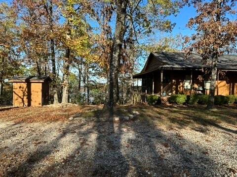 view of side of home featuring a shed