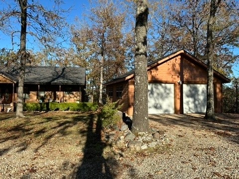 view of side of property featuring an outdoor structure and a garage