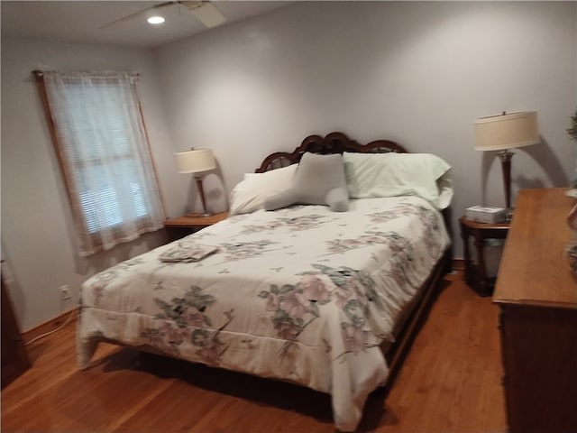 bedroom with ceiling fan and hardwood / wood-style flooring