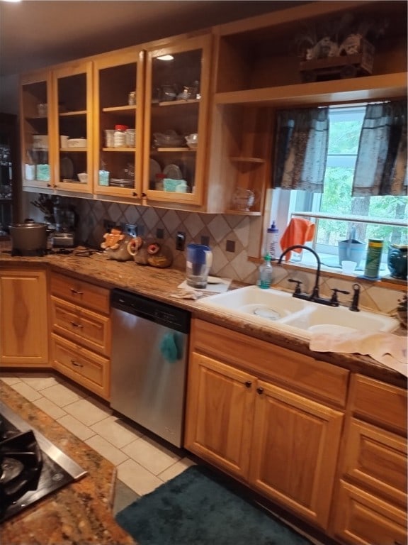 kitchen featuring sink, stainless steel dishwasher, decorative backsplash, light tile patterned flooring, and light stone counters