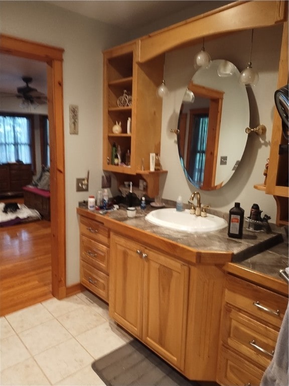 bathroom with ceiling fan, vanity, and wood-type flooring