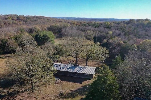 drone / aerial view featuring a forest view