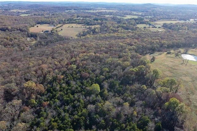 drone / aerial view featuring a wooded view
