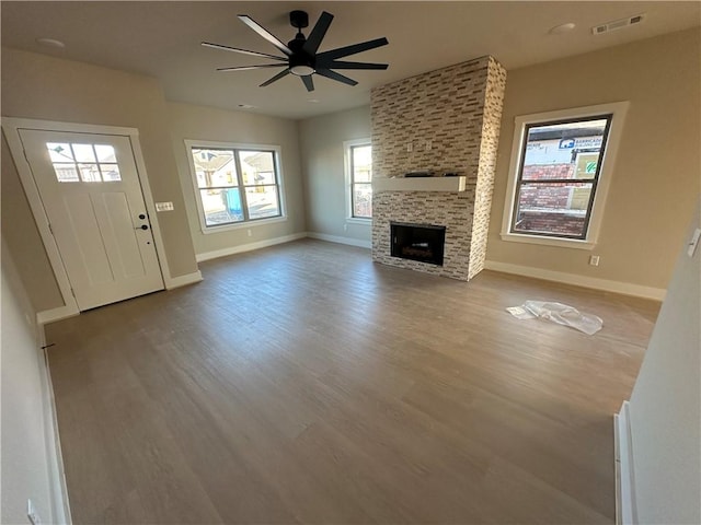 unfurnished living room with a fireplace, light hardwood / wood-style flooring, and ceiling fan