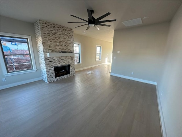 unfurnished living room featuring ceiling fan, a fireplace, and hardwood / wood-style flooring