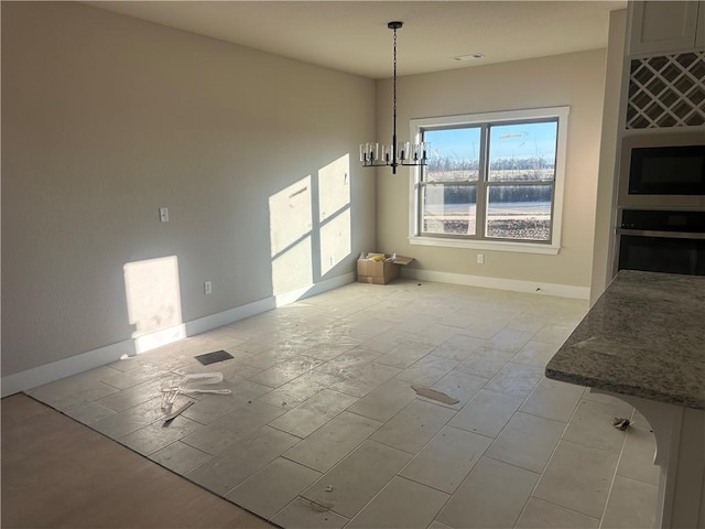 unfurnished dining area with a notable chandelier