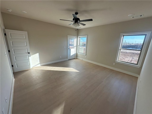 empty room featuring ceiling fan and light hardwood / wood-style floors