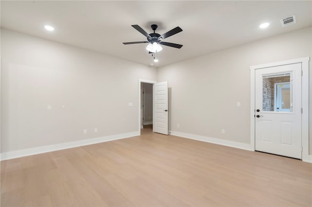 unfurnished room with baseboards, visible vents, light wood-style floors, ceiling fan, and recessed lighting