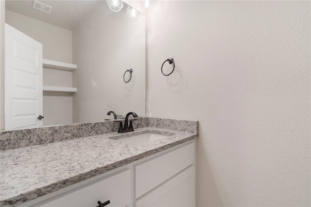 bathroom featuring vanity and visible vents