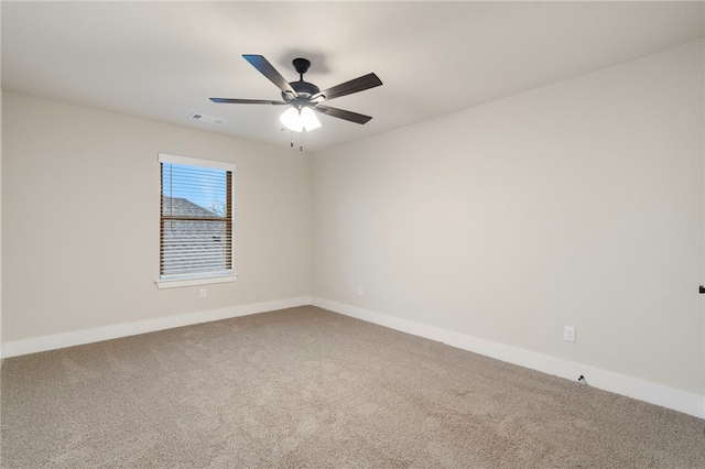 unfurnished room featuring baseboards, visible vents, and carpet