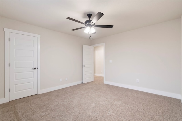 unfurnished bedroom with baseboards, carpet floors, and a ceiling fan