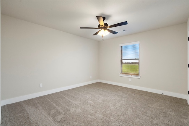 spare room featuring baseboards, visible vents, carpet flooring, and a ceiling fan
