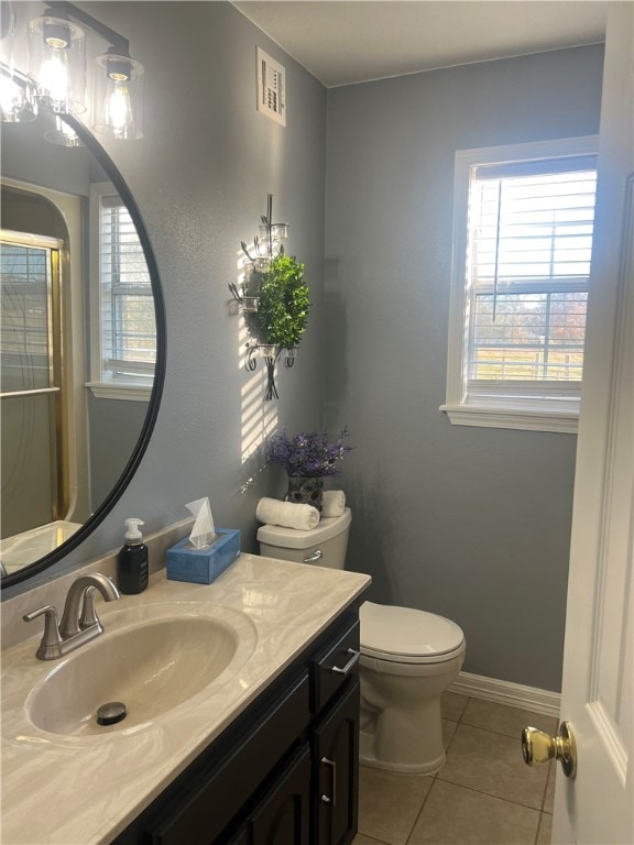 bathroom with tile patterned floors, vanity, and toilet