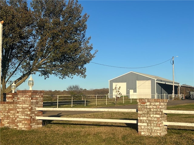 view of yard with an outbuilding and a rural view