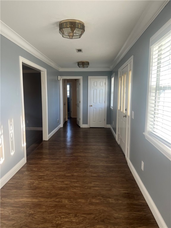 hallway featuring dark hardwood / wood-style flooring and ornamental molding