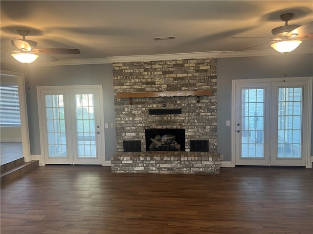 unfurnished living room featuring ceiling fan, a fireplace, dark hardwood / wood-style floors, and ornamental molding