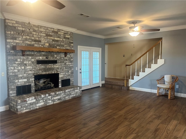 living room featuring dark hardwood / wood-style floors, ceiling fan, crown molding, and a fireplace