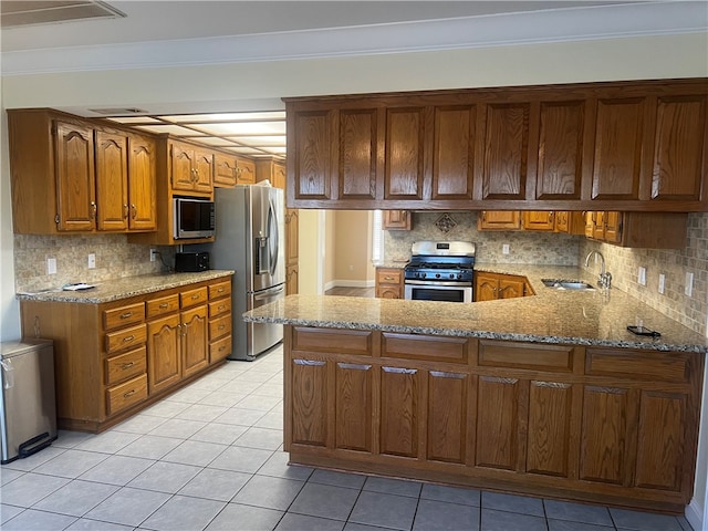 kitchen with kitchen peninsula, sink, stainless steel appliances, and ornamental molding