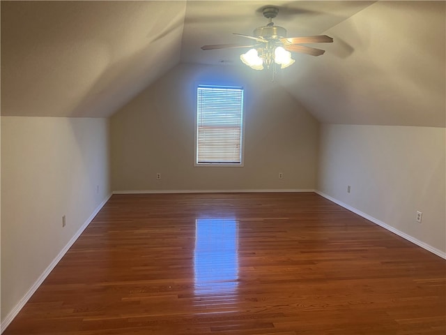 bonus room with ceiling fan, dark wood-type flooring, and vaulted ceiling