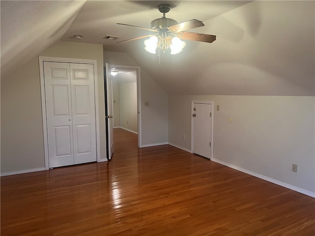 additional living space with lofted ceiling, ceiling fan, and dark wood-type flooring