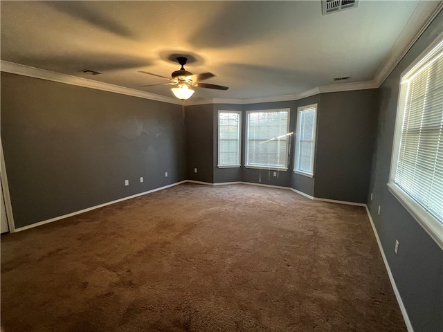 empty room featuring carpet floors, ceiling fan, and ornamental molding