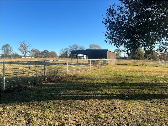 view of yard with an outbuilding and a rural view