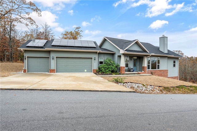 view of front facade with solar panels and a garage