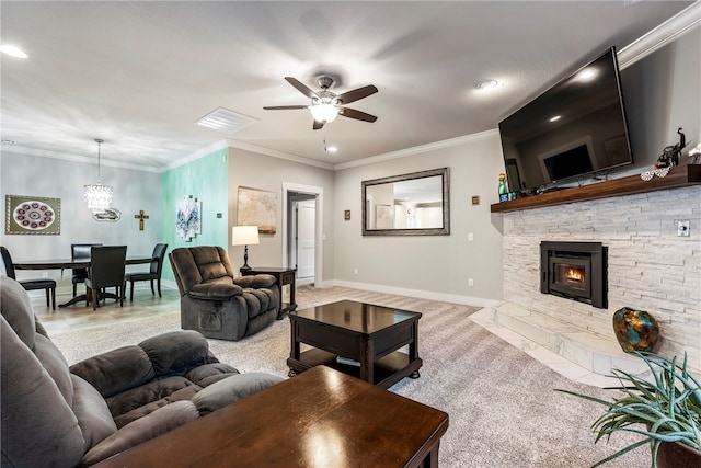 living room featuring visible vents, baseboards, a ceiling fan, crown molding, and a stone fireplace