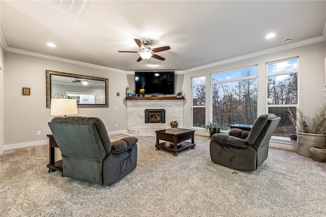 living room with carpet flooring, crown molding, a stone fireplace, and baseboards