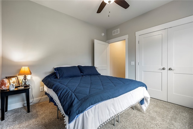 carpeted bedroom featuring a ceiling fan, baseboards, visible vents, and a closet