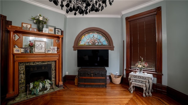 living area with hardwood / wood-style floors and ornamental molding