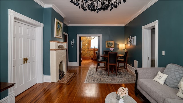 dining room featuring wood-type flooring, crown molding, and a brick fireplace