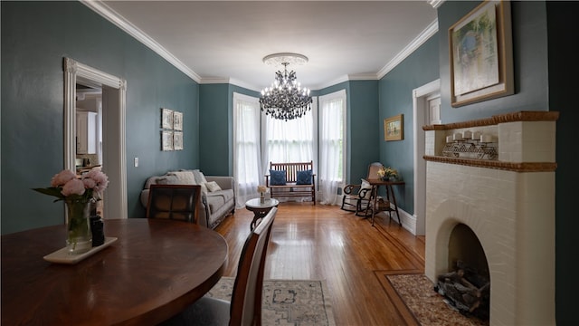 dining area with a chandelier, ornamental molding, and hardwood / wood-style flooring