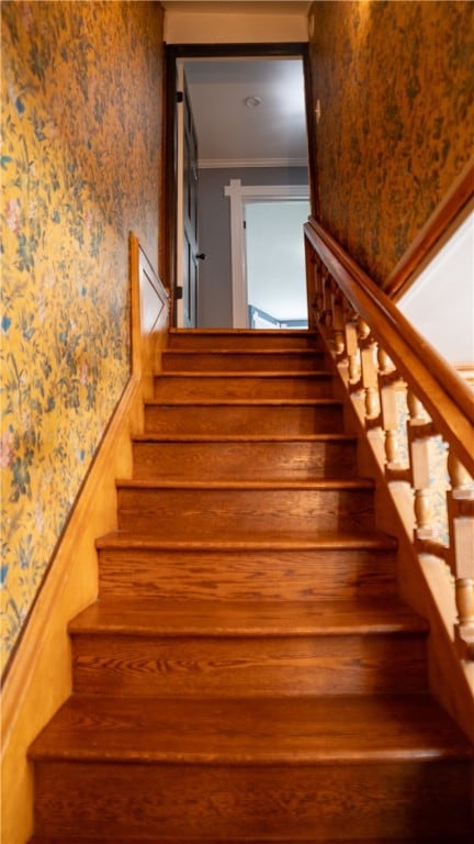 stairs featuring crown molding