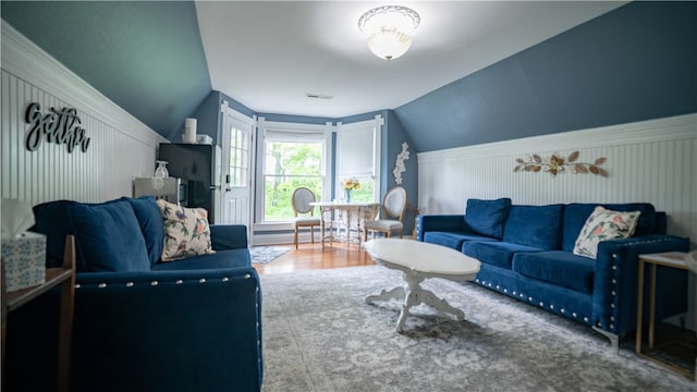 living room featuring hardwood / wood-style flooring and lofted ceiling