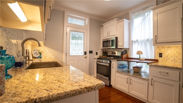 kitchen featuring light stone countertops, stainless steel appliances, dark wood-type flooring, sink, and white cabinetry