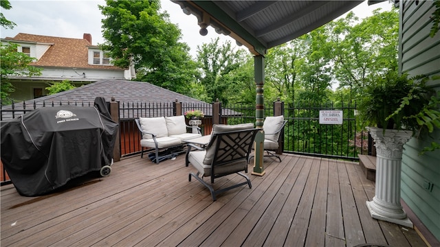 deck with a grill and an outdoor hangout area