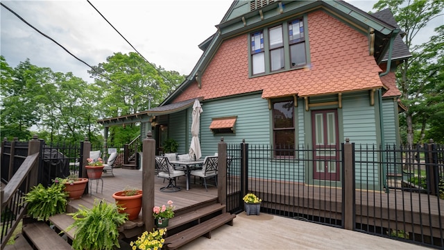 rear view of property with a wooden deck