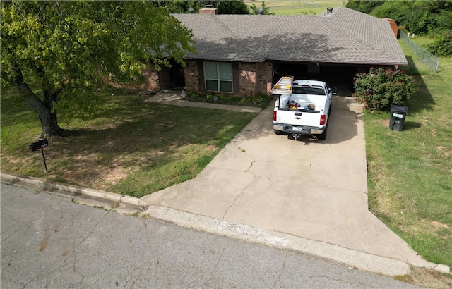 single story home with a front yard and a garage