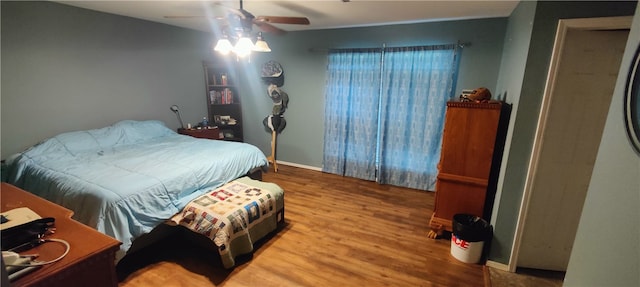 bedroom featuring hardwood / wood-style floors and ceiling fan