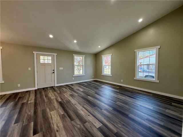 foyer with dark hardwood / wood-style flooring and high vaulted ceiling