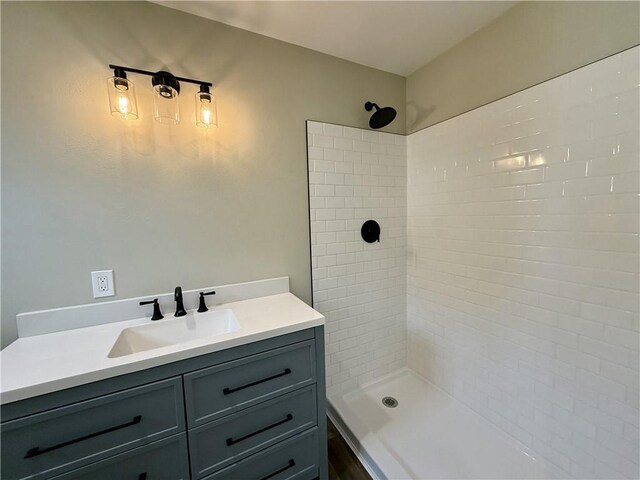 bathroom featuring vanity and a tile shower