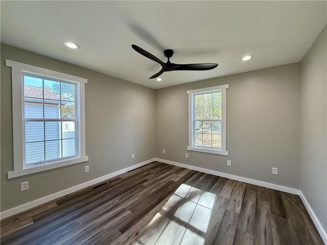 spare room with ceiling fan and dark hardwood / wood-style flooring