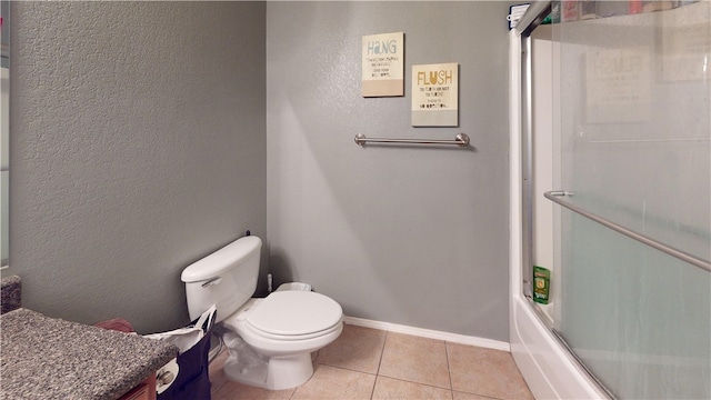 full bathroom with tile patterned floors, vanity, enclosed tub / shower combo, and toilet