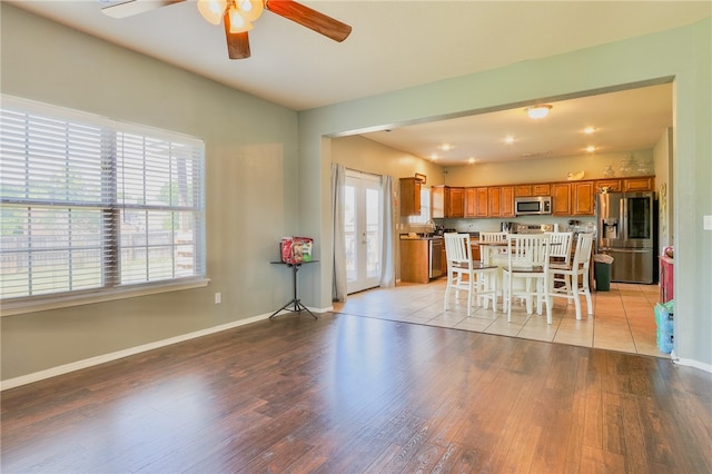 interior space with french doors, light hardwood / wood-style flooring, and ceiling fan