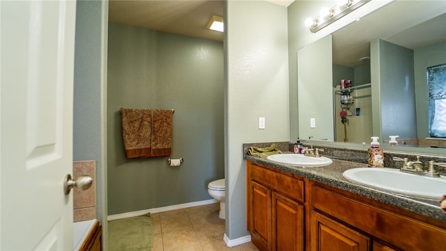 bathroom featuring tile patterned floors, vanity, and toilet